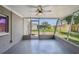 Screened porch with ceiling fan and backyard access at 3353 Columbus Dr, Holiday, FL 34691