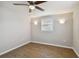 Bright bedroom with wood-look floors and ceiling fan at 3353 Columbus Dr, Holiday, FL 34691