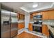 Stainless steel appliances and granite countertops in this kitchen at 3353 Columbus Dr, Holiday, FL 34691