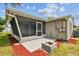 Backyard view of house with screened porch and fire pit at 3353 Columbus Dr, Holiday, FL 34691