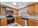 Updated kitchen with wood cabinets and granite countertops at 3353 Columbus Dr, Holiday, FL 34691