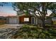 Newly renovated 1-story home with gray exterior, wood siding accents, and a landscaped lawn at 3353 Columbus Dr, Holiday, FL 34691
