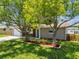 Updated ranch home with a gray exterior and large shade trees at 3353 Columbus Dr, Holiday, FL 34691