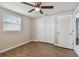 Bright bedroom with wood-look floors and double doors closet at 3353 Columbus Dr, Holiday, FL 34691
