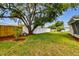 Large backyard with mature trees and fenced perimeter at 3353 Columbus Dr, Holiday, FL 34691