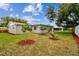 Spacious backyard with newly planted trees and red mulch at 3353 Columbus Dr, Holiday, FL 34691