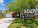 Charming ranch home with a two-car garage and mature landscaping at 3353 Columbus Dr, Holiday, FL 34691