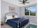 Spacious bedroom with a metal bed frame and window overlooking lush greenery at 6550 Shoreline Dr # 7101, Seminole, FL 33708