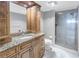 Bathroom with granite vanity, wood cabinets, and a glass shower at 2775 Kipps Colony S Dr # 204, St Petersburg, FL 33707