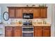 Well-equipped kitchen with granite counters, stainless steel appliances, and wood cabinets at 10426 48Th E Ct, Parrish, FL 34219