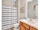 Bathroom with double sinks and striped shower curtain at 10426 48Th E Ct, Parrish, FL 34219