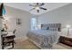 Bedroom with queen-size bed and built-in workspace at 10426 48Th E Ct, Parrish, FL 34219