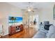 Gathering room with large screen TV, comfortable seating and hardwood floors at 10426 48Th E Ct, Parrish, FL 34219