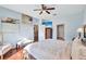King-size bed, wood floors, and access to other rooms at 10426 48Th E Ct, Parrish, FL 34219