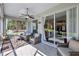 Relaxing screened porch with wicker furniture and view of backyard at 10426 48Th E Ct, Parrish, FL 34219