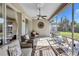 Relaxing screened patio with wicker furniture and view of backyard at 10426 48Th E Ct, Parrish, FL 34219