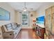 Gathering room featuring a comfy couch, large TV, and hardwood floors at 10426 48Th E Ct, Parrish, FL 34219