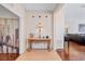 Entryway with console table, decorative lamp, and hardwood floors at 10426 48Th E Ct, Parrish, FL 34219