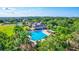 Resort-style community pool with surrounding lounge chairs and lush landscaping at 10426 48Th E Ct, Parrish, FL 34219