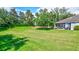 Spacious backyard with a large grassy area and patio at 10426 48Th E Ct, Parrish, FL 34219