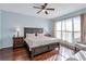 Spacious bedroom with king-size bed and wood floors at 10426 48Th E Ct, Parrish, FL 34219
