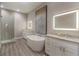Elegant bathroom with double vanity, soaking tub, and walk-in shower at 17B Franklin S Ct, St Petersburg, FL 33711