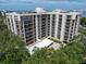Condo building exterior with balconies and landscaping at 150 Belleview Blvd # 704, Belleair, FL 33756