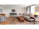 Living room with hardwood floors, comfortable seating and green accent table at 150 Belleview Blvd # 704, Belleair, FL 33756