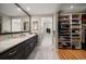Spa-like bathroom with marble floors, double vanity, and walk-in closet at 150 Belleview Blvd # 704, Belleair, FL 33756