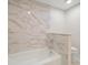 Elegant bathroom with marble tile and soaking tub at 150 Belleview Blvd # 704, Belleair, FL 33756