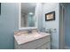 Clean bathroom with light blue walls and granite countertop at 150 Belleview Blvd # 704, Belleair, FL 33756