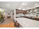 Modern kitchen with dark wood cabinets, quartz countertops and stainless steel appliances at 150 Belleview Blvd # 704, Belleair, FL 33756
