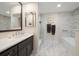 Elegant bathroom with marble flooring, a soaking tub, and a walk-in shower at 150 Belleview Blvd # 704, Belleair, FL 33756