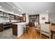 Open concept kitchen and dining area with hardwood floors and breakfast bar at 150 Belleview Blvd # 704, Belleair, FL 33756