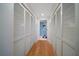 Long hallway with ample closet space and wood floors at 150 Belleview Blvd # 704, Belleair, FL 33756