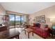 Living room with hardwood floors, balcony access and city views at 150 Belleview Blvd # 704, Belleair, FL 33756