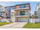 Contemporary two-story home with a large garage, sleek lines, and a well-manicured lawn at 1735 Massachusetts Ne Ave, St Petersburg, FL 33703