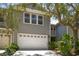 Charming two-story home with a two-car garage and beautifully landscaped front yard at 2848 Bayshore Trails Dr, Tampa, FL 33611
