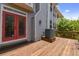 Wooden deck with red doors and surrounding trees at 2848 Bayshore Trails Dr, Tampa, FL 33611