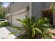 Partial view of house exterior, highlighting landscaping and garage at 2848 Bayshore Trails Dr, Tampa, FL 33611