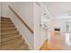 Well-lit carpeted staircase with wood railing leading to the upper level at 2848 Bayshore Trails Dr, Tampa, FL 33611