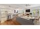 Open concept living room with hardwood floors, fireplace, and access to a balcony at 2848 Bayshore Trails Dr, Tampa, FL 33611