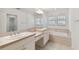 Double vanity bathroom with a bathtub and large mirror at 2848 Bayshore Trails Dr, Tampa, FL 33611