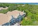 Aerial view of townhouses with bay views, showcasing private decks and lush landscaping at 2848 Bayshore Trails Dr, Tampa, FL 33611