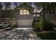 Two-story house with a gray exterior, two-car garage, and landscaped yard at 2848 Bayshore Trails Dr, Tampa, FL 33611