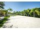 Sand volleyball court with surrounding greenery at 2746 Via Tivoli # 132B, Clearwater, FL 33764