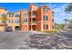 Front view of a three-story condo building with parking at 2746 Via Tivoli # 132B, Clearwater, FL 33764