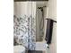 Bathroom with tub shower combo, updated fixtures, and a floral shower curtain at 2746 Via Tivoli # 132B, Clearwater, FL 33764