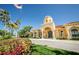 Community clubhouse with landscaping and a flag at 2746 Via Tivoli # 132B, Clearwater, FL 33764