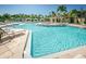 Large community pool with plenty of lounge chairs and cabanas at 2746 Via Tivoli # 132B, Clearwater, FL 33764